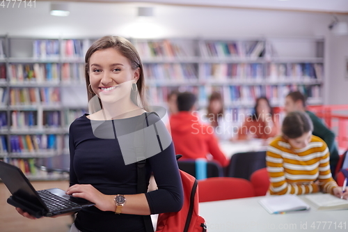 Image of the student uses a notebook and a school library