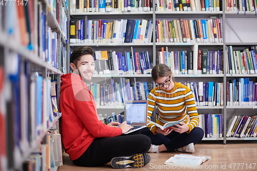 Image of the students uses a notebook, laptop and a school library