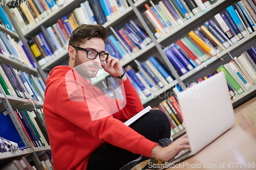 Image of the students uses a notebook, laptop and a school library