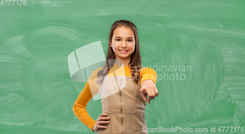 Image of smiling teenage student girl pointing to camera