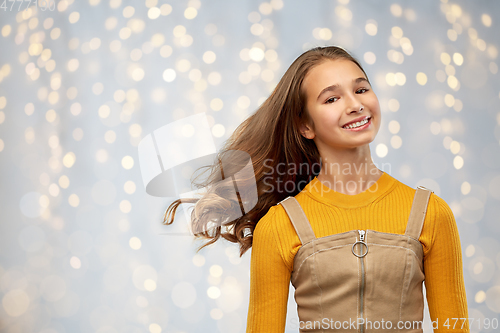 Image of young teenage girl with waving long hair