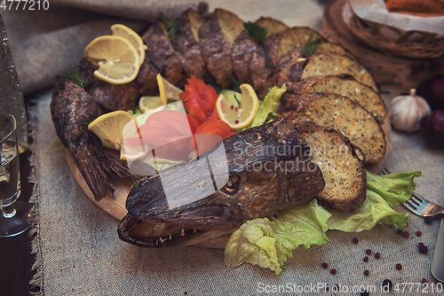 Image of Stuffed pike with vegetables and greens.