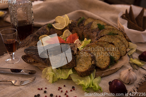 Image of Stuffed pike with vegetables and greens.