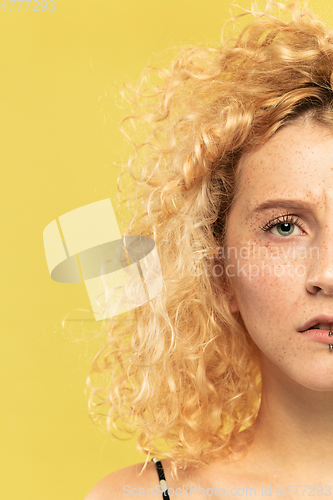 Image of Caucasian young woman\'s close up portrait on yellow background