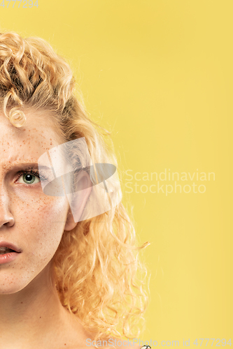 Image of Caucasian young woman\'s close up portrait on yellow background