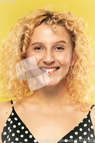 Image of Caucasian young woman\'s close up portrait on yellow background