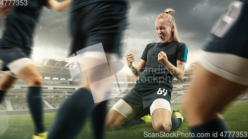 Image of Female soccer or football players kicking ball at the stadium