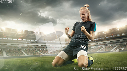 Image of Female soccer or football players kicking ball at the stadium