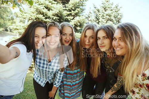 Image of Happy women outdoors on sunny day. Girl power concept.