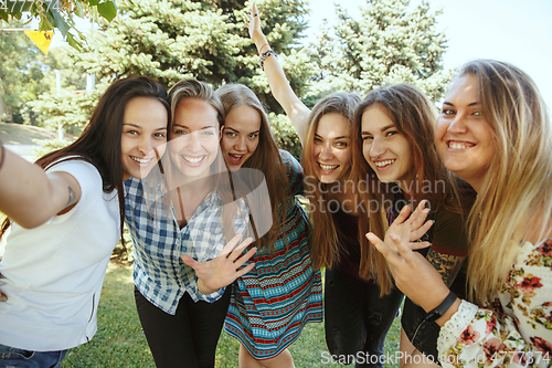 Image of Happy women outdoors on sunny day. Girl power concept.