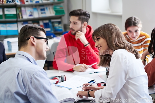 Image of students group working on school project together on tablet computer at modern university