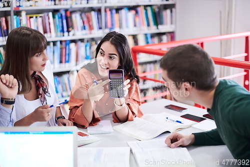 Image of students group working on school project together on tablet computer at modern university