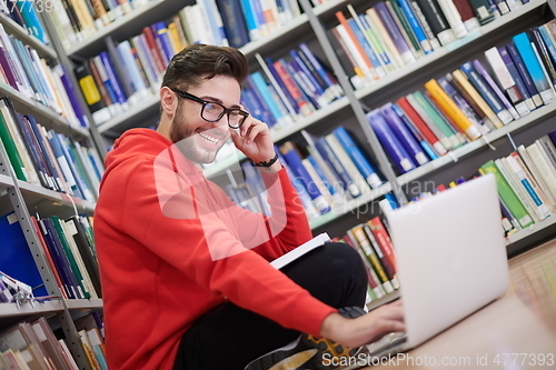 Image of the students uses a notebook, laptop and a school library