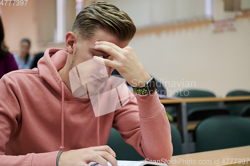 Image of the student has a headache in class