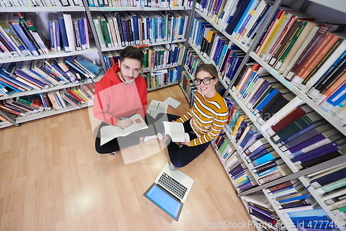 Image of the students uses a notebook, laptop and a school library