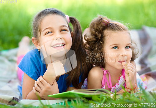 Image of Two little girls are reading book