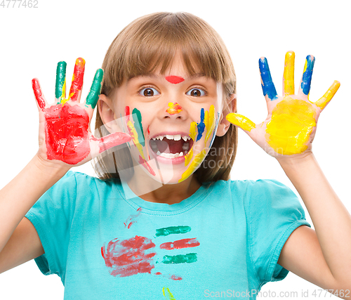 Image of Portrait of a cute girl playing with paints