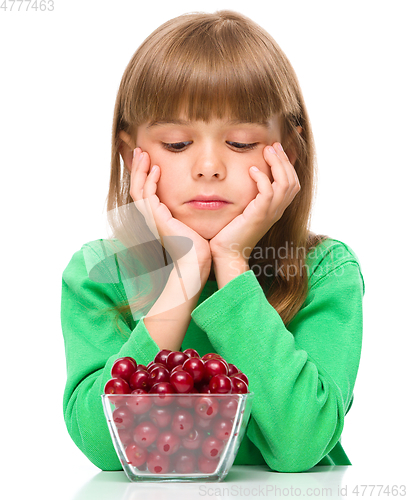 Image of Cute girl doesn\'t want to eat cherries