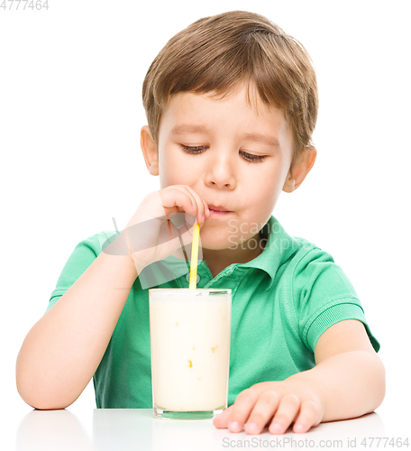 Image of Cute little boy with a glass of milk