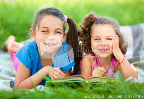 Image of Two little girls are reading book
