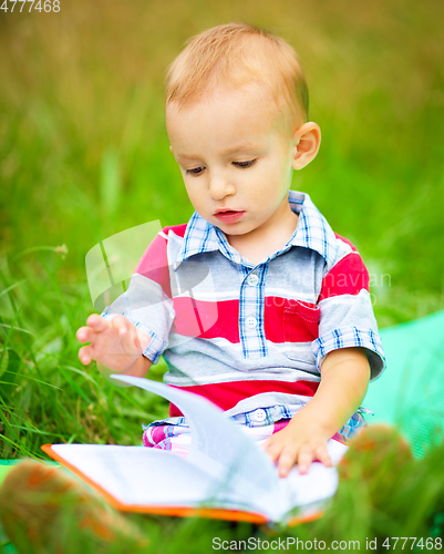 Image of Little boy is reading book