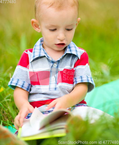 Image of Little boy is reading book