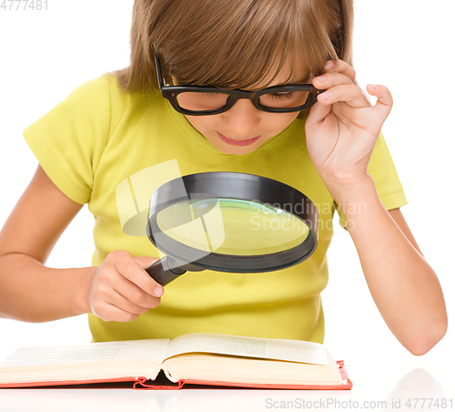 Image of Little girl is reading book