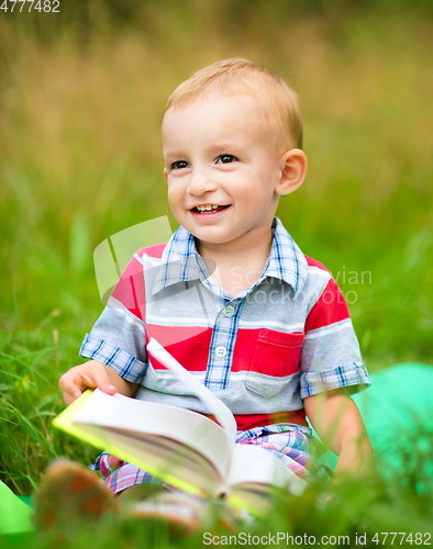 Image of Little boy is reading book