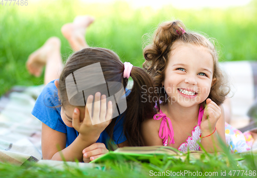 Image of Two little girls are reading book