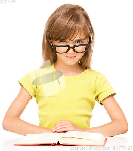 Image of Little girl is reading a book