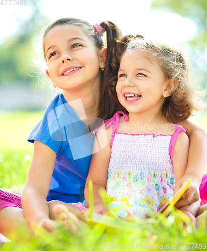 Image of Two little girls are reading books