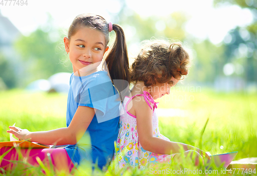 Image of Two little girls are reading books