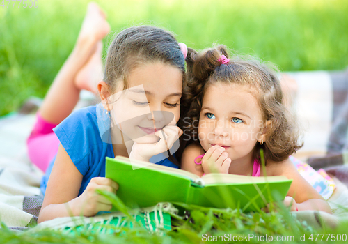 Image of Two little girls are reading book