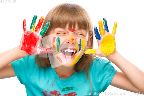 Image of Portrait of a cute girl playing with paints