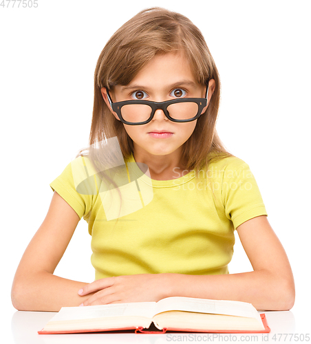 Image of Little girl is reading a book