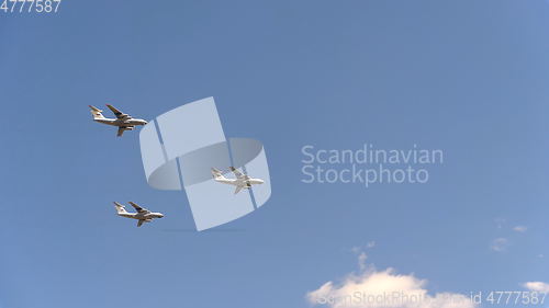 Image of Military transport aircraft Il-72 fly in blue sky