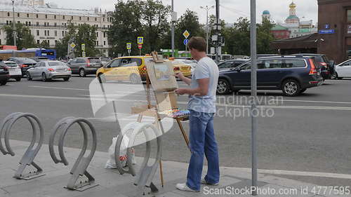 Image of MOSCOW - AUGUST 26: Street artist paints a urban landscape on August 26, 2017 in Moscow, Russia.