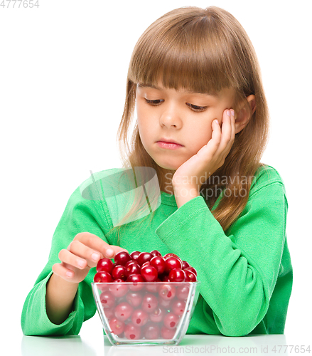 Image of Cute girl doesn\'t want to eat cherries