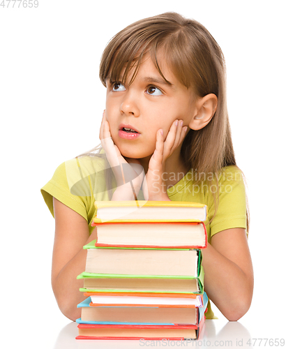 Image of Little girl with a pile of books