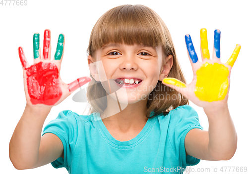 Image of Portrait of a cute girl playing with paints