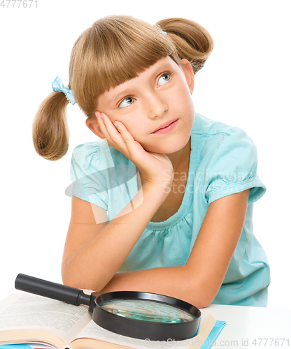 Image of Little girl is reading book