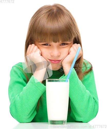 Image of Gloomy little girl doesn\'t want to drink milk