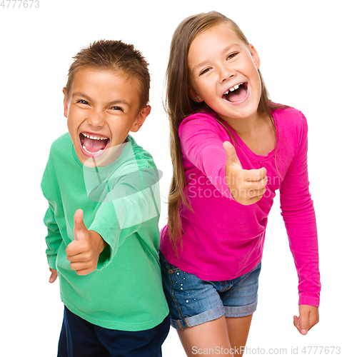 Image of Little boy and girl are showing thumb up sign