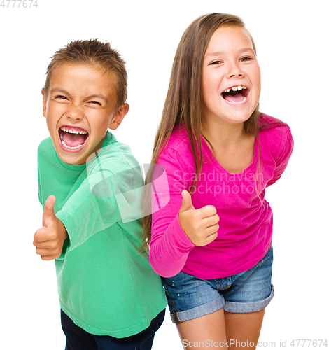 Image of Little boy and girl are showing thumb up sign