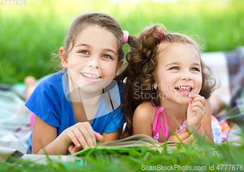 Image of Two little girls are reading book