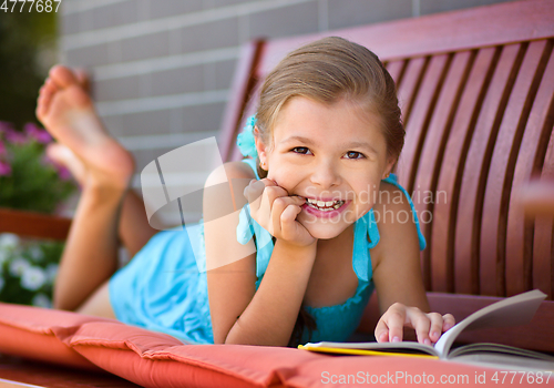 Image of Little girl is reading a book
