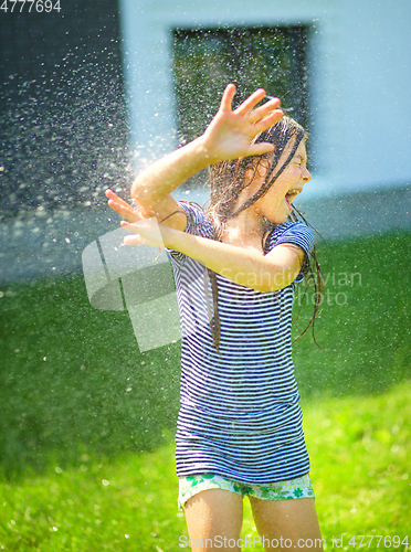 Image of Happy girl is playing under rain