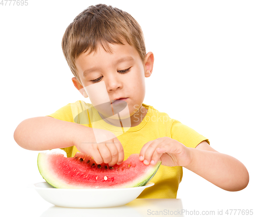 Image of Little boy is eating watermelon