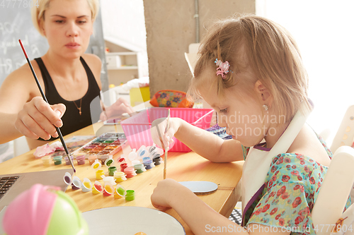 Image of Cute little girl painting on home interior background