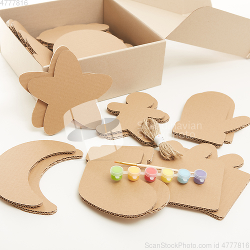 Image of DIY christmas decorations from cardboard paper. Homemade Christmas ornament from reused paper. Craft ideas for kids.